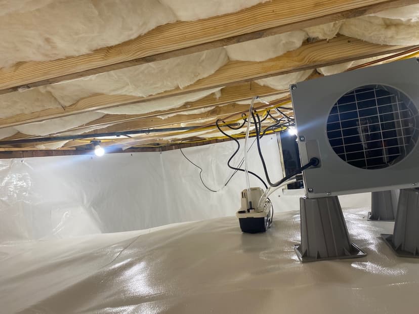 HydroHelp911 Crawl Space & Foundation Repair installing a vapor barrier, dehumidifier, and insulation in a crawl space.