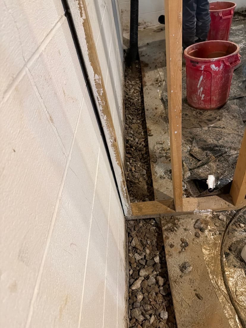 HydroHelp911 Crawl Space & Foundation Repair installing an interior drainage system in a basement.