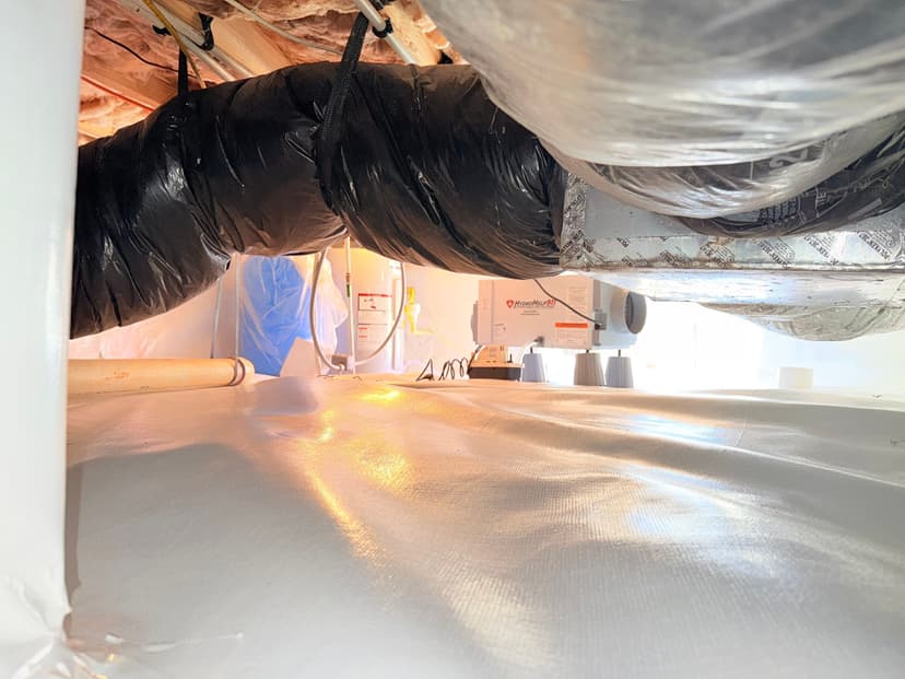 HydroHelp911 Crawl Space & Foundation Repair installing a dehumidifier and vapor barrier in a sealed crawl space.