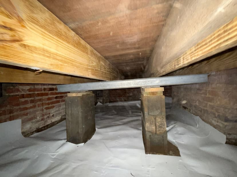 HydroHelp911 Crawl Space & Foundation Repair installing crawl space jacks, steel beams, and a vapor barrier.
