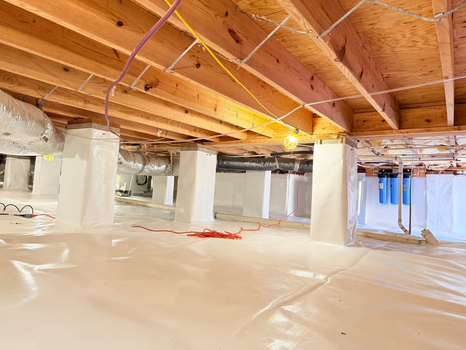 HydroHelp911 Crawl Space & Foundation Repair installing a crawl space encapsulation system with white vapor barrier
