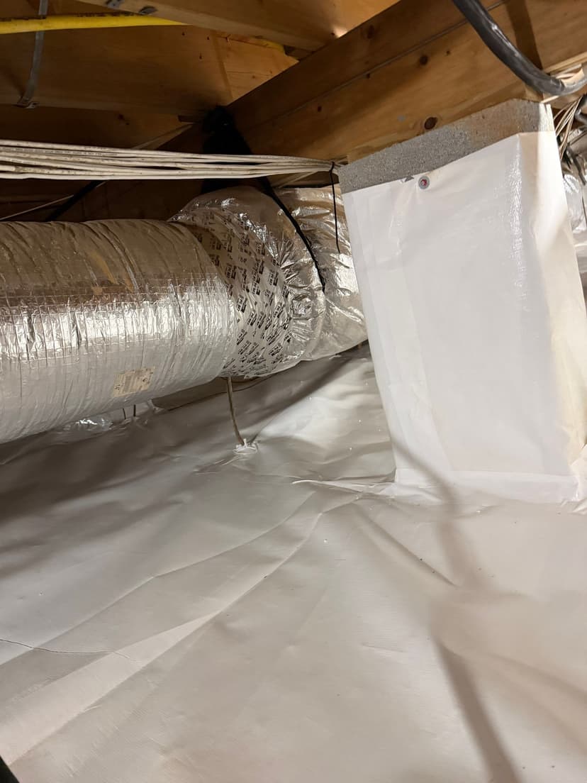 HydroHelp911 Crawl Space & Foundation Repair installing a white vapor barrier in a crawl space with insulated HVAC ducts