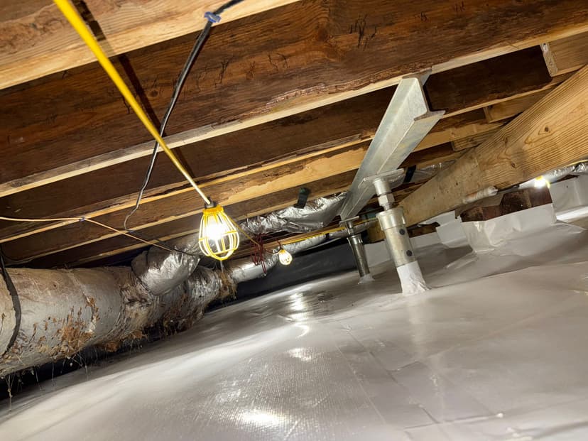 HydroHelp911 Crawl Space & Foundation Repair installing crawl space structural repair jacks and a vapor barrier.