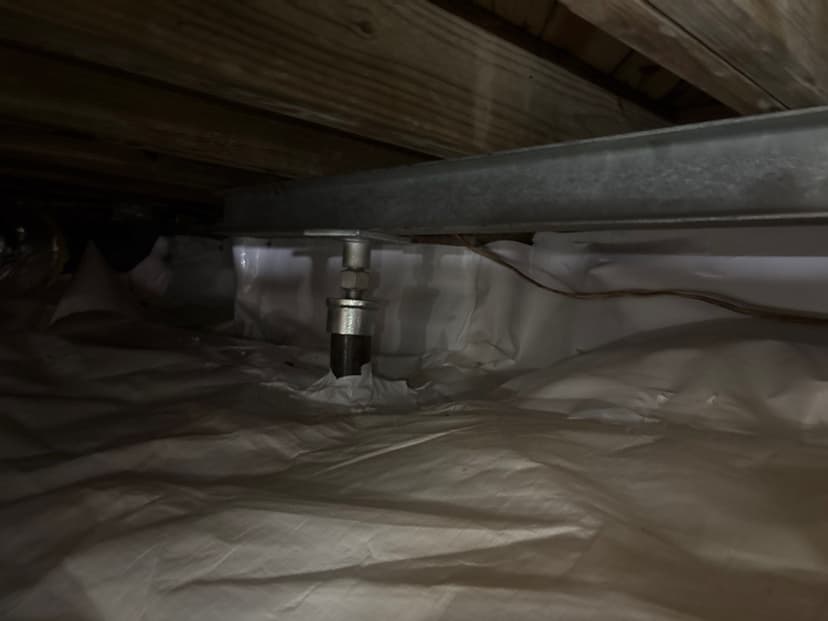 HydroHelp911 Crawl Space & Foundation Repair installing adjustable steel jacks and support beams in a crawl space.