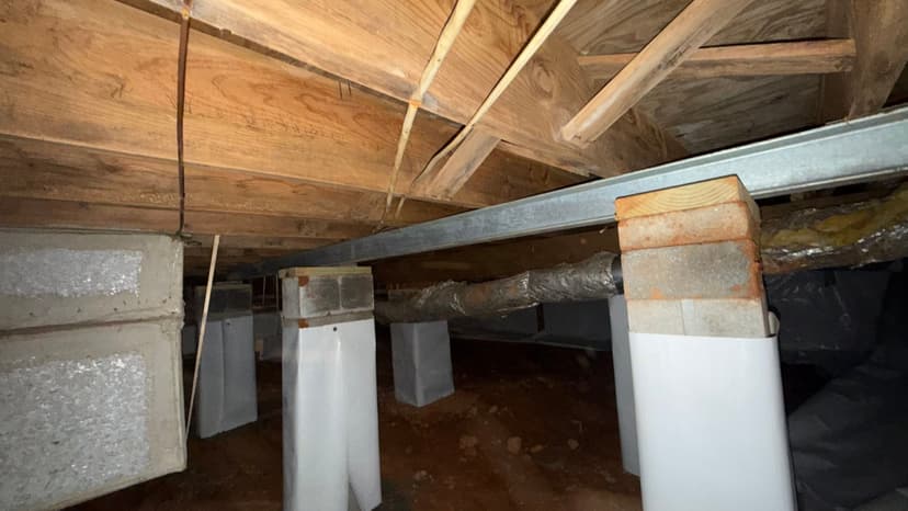 HydroHelp911 Crawl Space & Foundation Repair installing crawl space jacks and a steel beam for joist reinforcement.