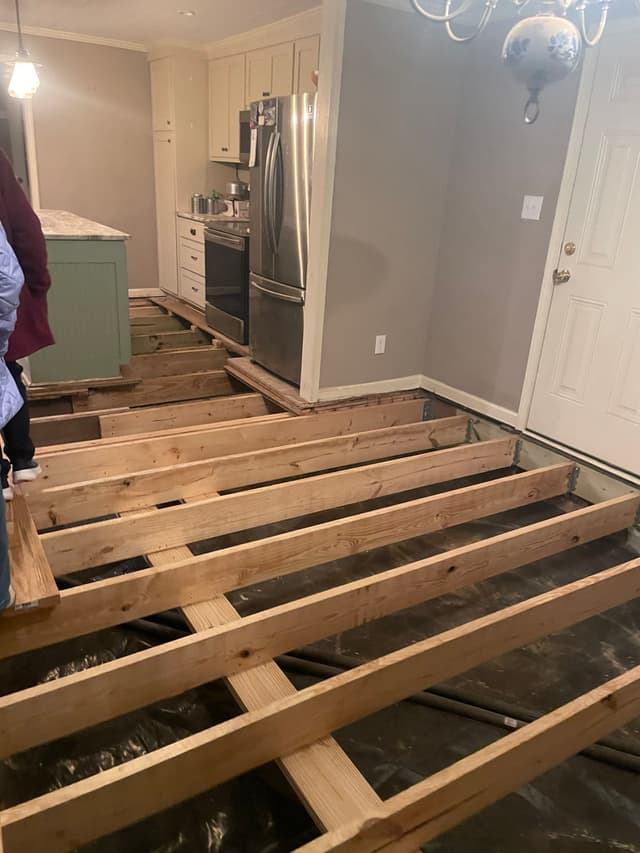 HydroHelp911 Crawl Space & Foundation Repair crew repairing wooden floor joists in a crawl space.