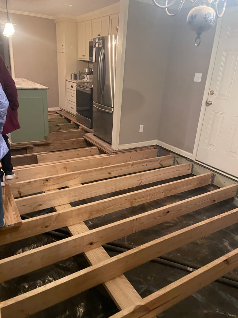 HydroHelp911 Crawl Space & Foundation Repair crew repairing wooden floor joists in a crawl space.