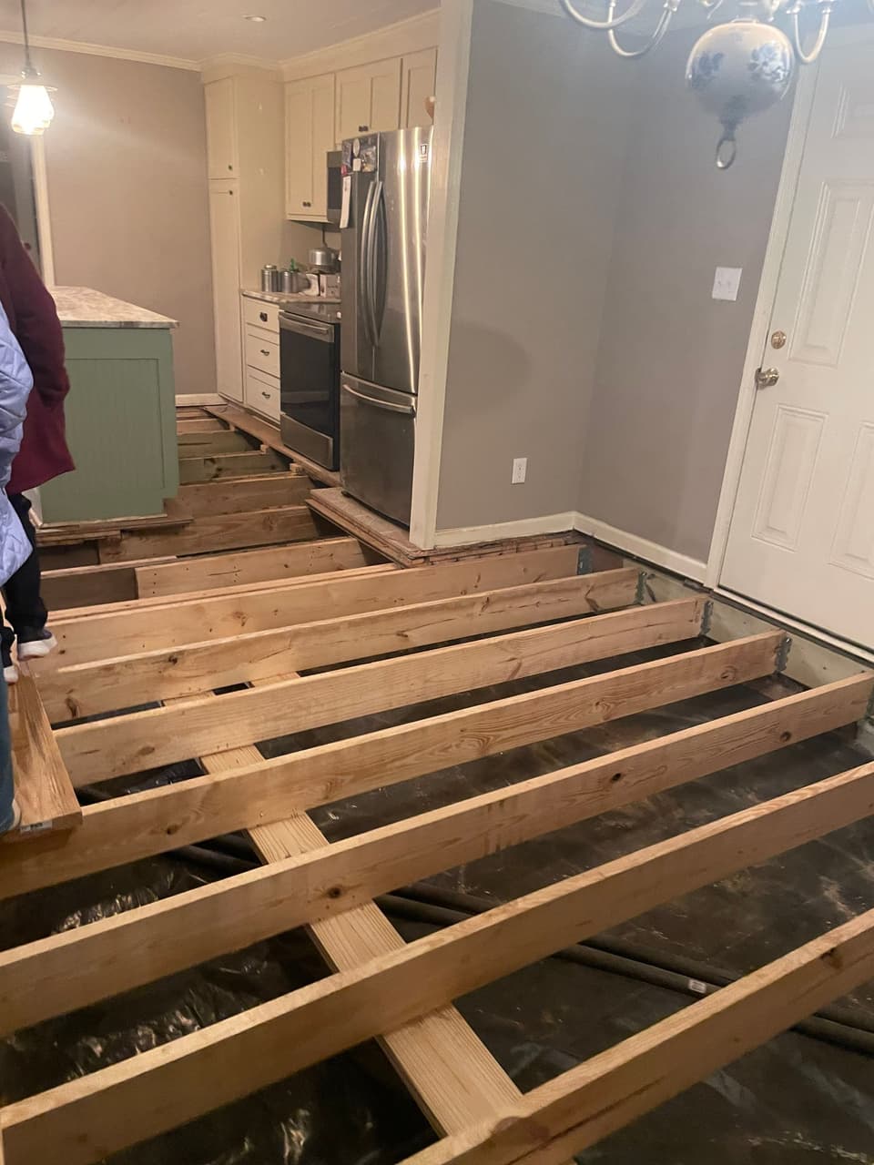 HydroHelp911 Crawl Space & Foundation Repair crew repairing wooden floor joists in a crawl space.