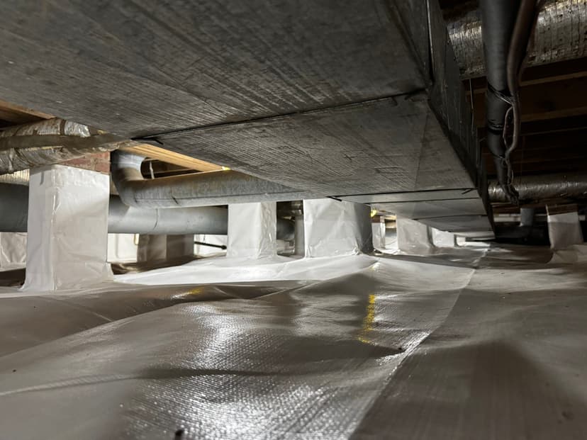 HydroHelp911 Crawl Space & Foundation Repair installing a vapor barrier over the crawl space floor