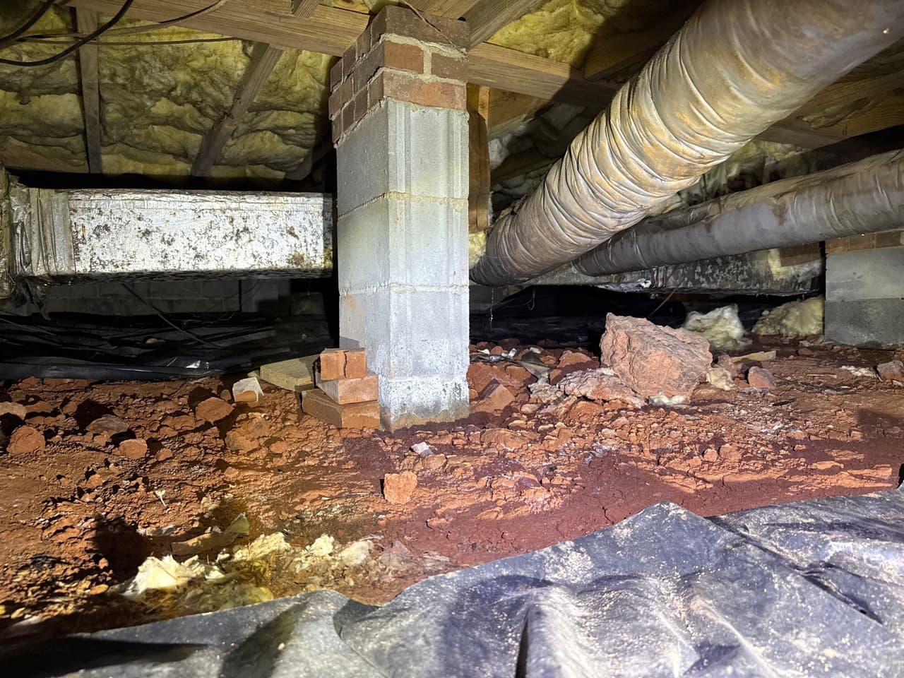 HydroHelp911 Crawl Space & Foundation Repair inspecting moisture in a crawl space with deteriorating insulation.