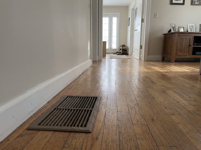 HydroHelp911 Crawl Space & Foundation Repair inspecting condensation on an HVAC vent, a sign of high humidity.
