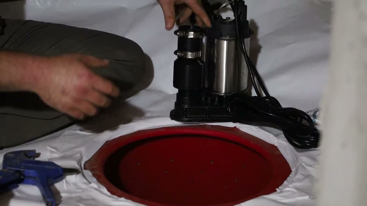 Installing a sump pump into a crawl space sump pit.