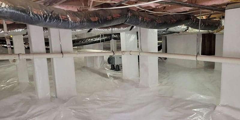 Encapsulated crawl space with a white liner, insulated ducts and a dehumidifier