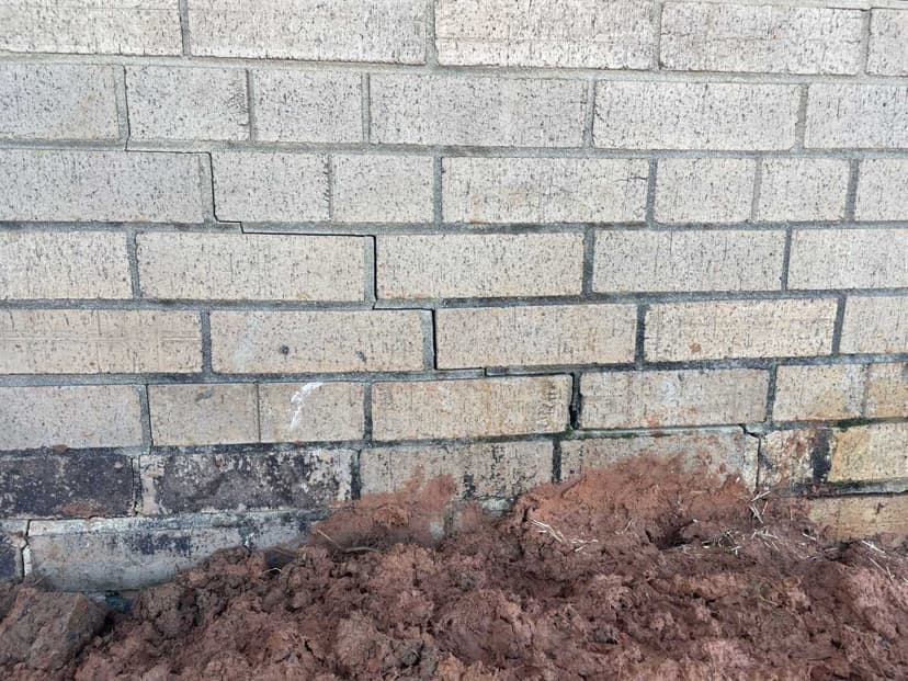 Stair step crack in the mortar of a brick foundation wall