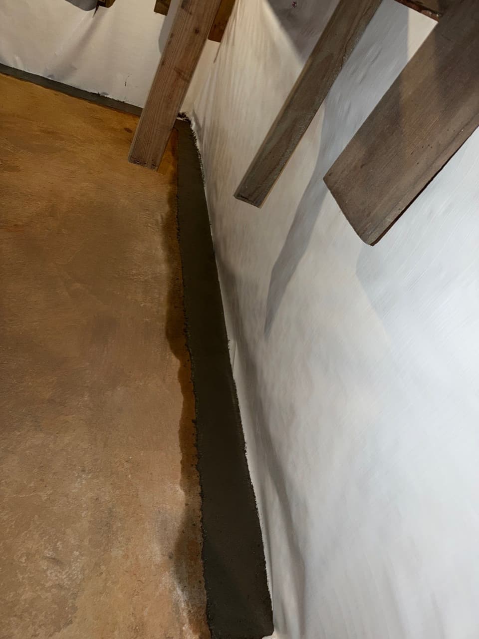 HydroHelp911 Crawl Space & Foundation Repair installing a vapor barrier and interior drainage trench.