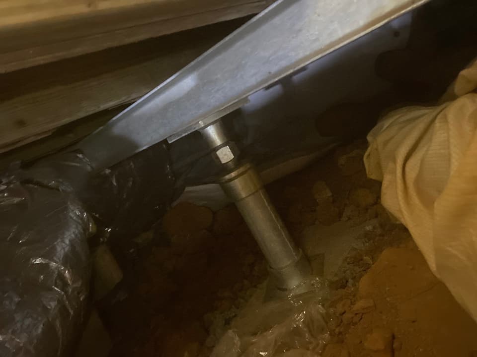 HydroHelp911 Crawl Space & Foundation Repair installing steel support post and beam for floor joist repair.