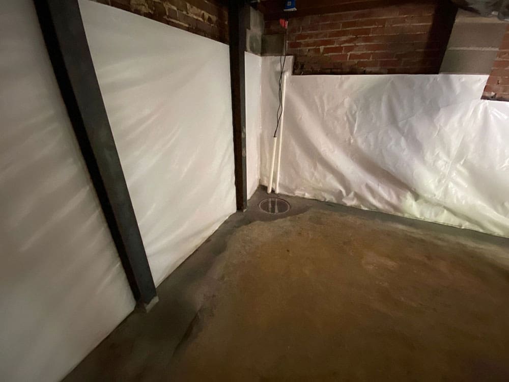 Basement with a white wall liner and steel wall braces