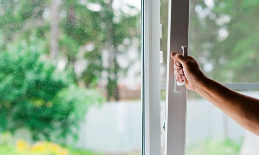 Hand pulling open a sliding window