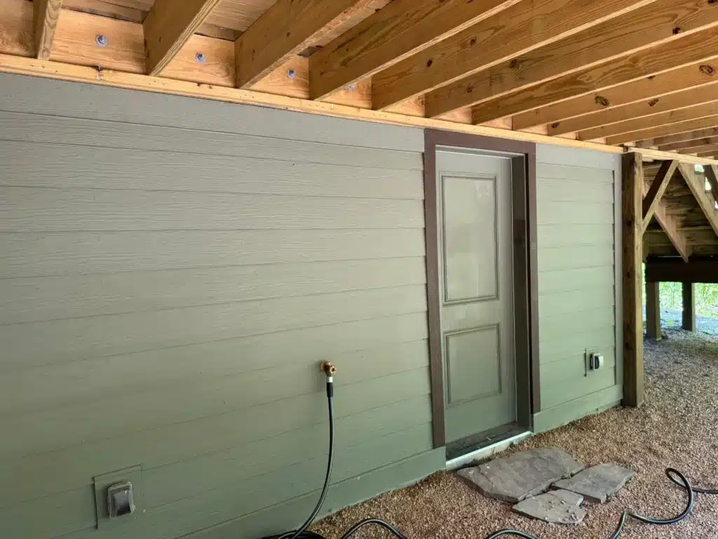New pressure treated deck joists attached to the house wall with galvanized through bolts