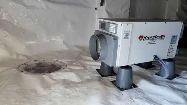 HydroHelp911 dehumidifier on stands in an encapsulated crawl space